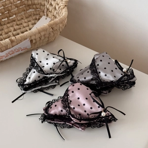 Detailed view of satin polka dot lace panties with bows and pearls in a three-pack
