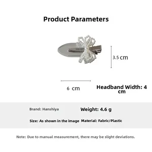 Detail showing pearl bow hair clip dimensions 6cm by 3.5cm on a silver duckbill base