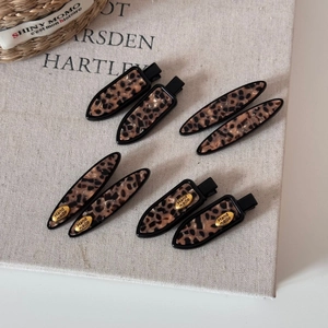 Detailed set of leopard print tortoiseshell hair clips with gold handmade accents