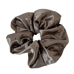 Polished brown satin scrunchie with classic black polka dots on white background