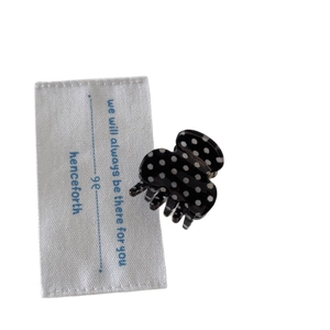 Mini black polka dot hair claw clip with white spots for elegant half-up hairstyles