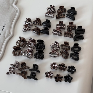 Detail view of leopard print and tortoiseshell mini hair claw clips in various shapes