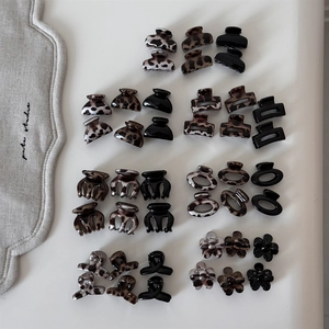 Detailed flat lay of mini resin claw clips in leopard print and neutral colors