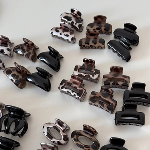 Flat lay of diverse leopard print and marble pattern mini hair claw clips for women