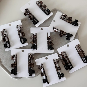 Detailed set of leopard print and black acetate hair clips with metal springs