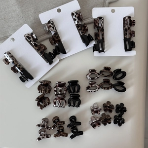 Flat lay of leopard print hair clips and flower claw clips in assorted patterns