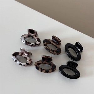 Mini leopard print hair clips set in brown and black colors on a neutral background
