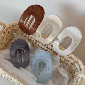 Elegant Morandi macaron hair claws in five colors displayed in a woven basket
