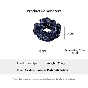 Detail showing 13cm diameter and 23g weight of navy blue polka dot fabric hair scrunchie