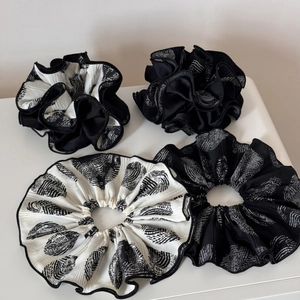 Set of 4 pleated scrunchies in black and white geometric patterns for ponytails