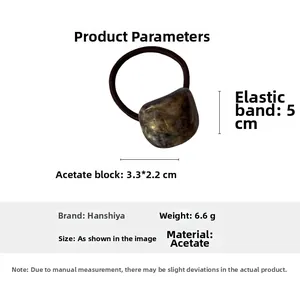 Detail view of tortoiseshell acetate geometric hair tie with technical specifications