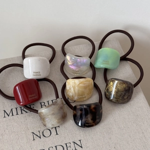 Set of 8 geometric acetate hair ties with vintage gold labels for ponytail styling