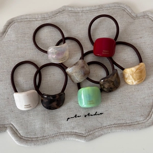 8-piece set of geometric acetate hair ties in various colors with France Handmade text