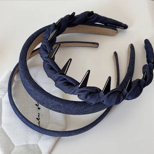 Close-up detail of three denim headbands featuring vintage blue fabric and hand made labels