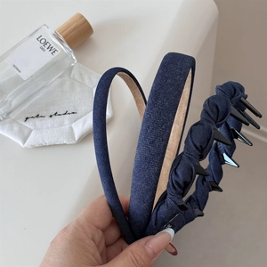 Close-up of three dark blue denim headbands set with non-slip lining and stylish texture