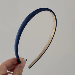 Detailed close-up of dark blue denim headband with non-slip lining and neat stitching