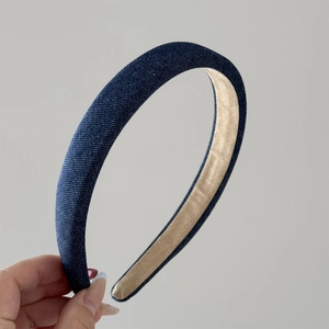 Detail view of vintage denim blue headband with thick padded design and non-slip lining
