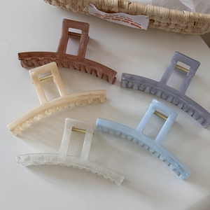 Macro detail of large translucent acetate hair claws in various marble colors and textures