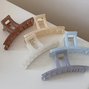 Macro detail of five assorted translucent jelly shark hair clips in various pastel colors