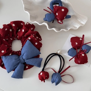 Detail of red polka dot and denim bow hair accessories set with pearls and scrunchie