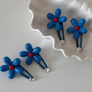 Blue flower hair clips set with red center beads and sparkling rhinestones for women
