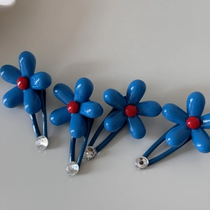 Set of four blue flower hair clips with red bead centers and clear rhinestone accents