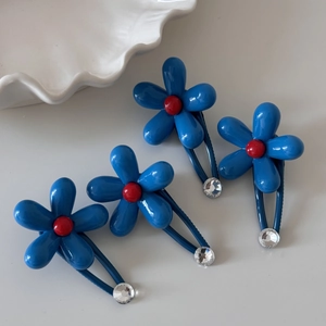 Set of four blue flower hair clips with red bead centers and sparkling rhinestones