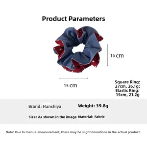 Detail view of 15cm oversized red polka dot and denim blue fabric scrunchie with measurements