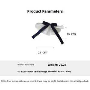 Detailed dimensions of the denim bow hair clip with white lace trim, 23cm by 19cm size