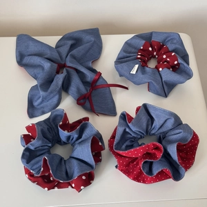 Detail view of denim blue and red polka dot scrunchies set with hand made label