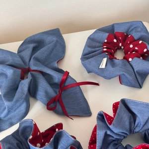Detail showing blue denim and red polka dot fabric hair scrunchies with handmade labels