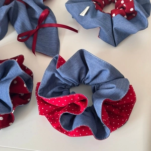 Detail of red and denim blue scrunchie with white polka dots and handmade label