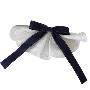 Charming pet lace collar with a dark blue denim bow and intricate white lace detailing