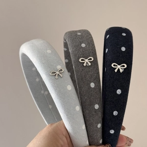 Detail of polka dot sponge headbands with silver metal bow and small rhinestone
