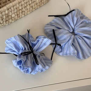 Detail of blue striped scrunchies with black bows for ballet style hairstyles