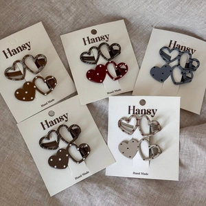 Polka dot and checkered heart-shaped hair clips set in neutral earth tones for women