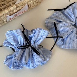 Blue striped scrunchies with black ribbons in a ballet-inspired aesthetic