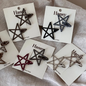 Set of 10 star shaped hair clips with polka dots and stripes on display card