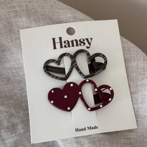 Detail of polka dot and striped heart-shaped hair clips on a cardboard display