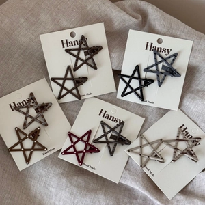 Detailed close-up of colorful polka dot and star-shaped hair clips in various patterns