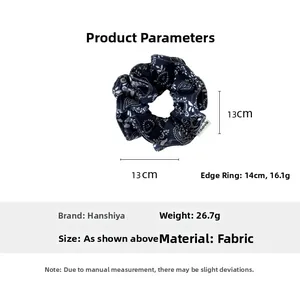 Detailed view of dark blue floral scrunchie with 13cm diameter and fabric texture
