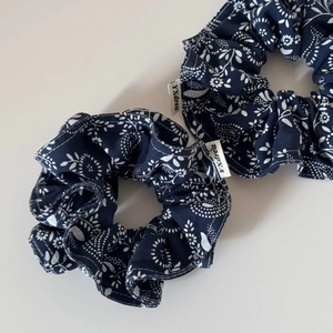 Set of two navy floral cotton scrunchies with delicate white flower patterns for hair