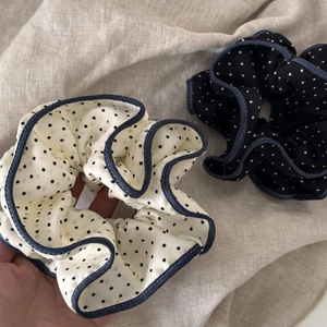 Close-up of polka dot hair scrunchies with denim blue edge and satin texture fabric