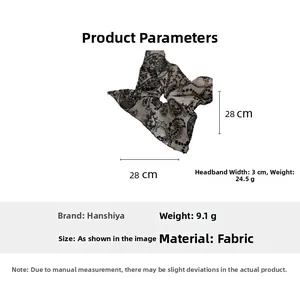 Detailed view of paisley fabric hair scrunchie with size 28cm and weight 9.1g markers