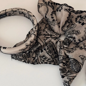 Detail of bohemian paisley floral headband and oversized scrunchie hair accessory set