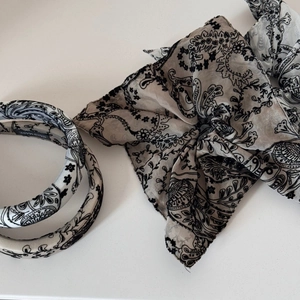 Detail of beige satin headband and scrunchie set with vintage floral paisley patterns