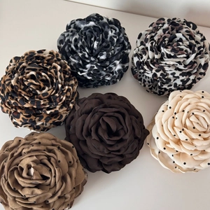 Detailed top view of large fabric leopard and polka dot print flower hair claw clips