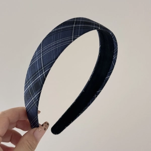 Close-up of blue and black plaid headband with a cotton fabric texture and non-slip inner