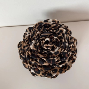 Detailed view of the leopard print fabric flower petals with layered rose design texture
