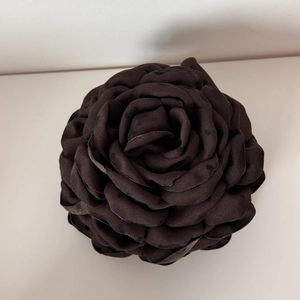 Detailed view of the layered brown fabric rose hair claw with elegant black polka dots
